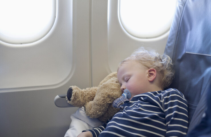 Germany, Boy sleeping in plane