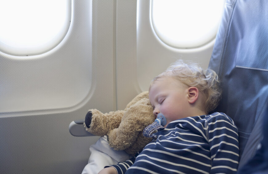 Germany, Boy sleeping in plane