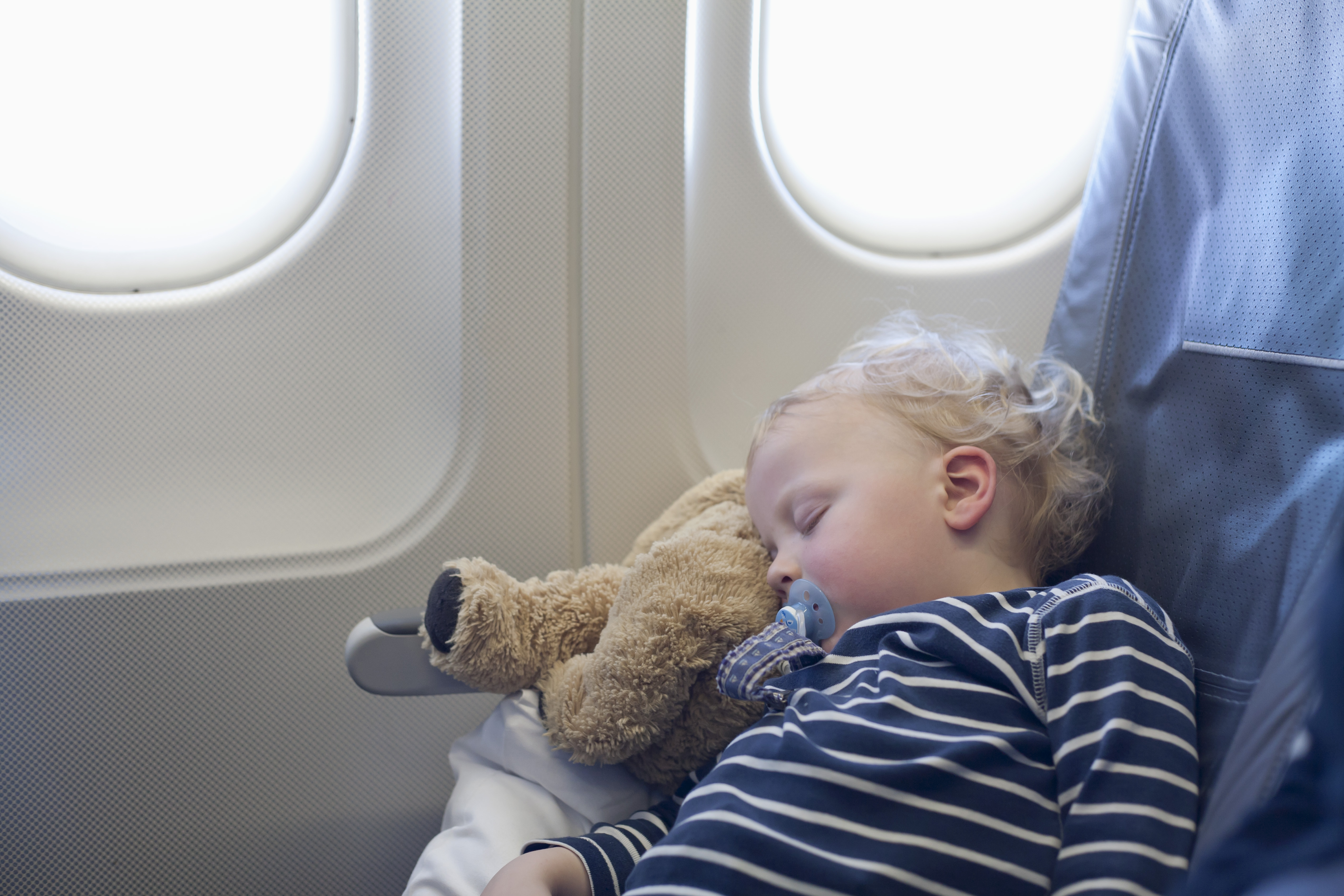 Germany, Boy sleeping in plane