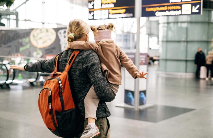 man-and-child-at-the-airport-with-backpack-2025-03-08-05-17-02-utc