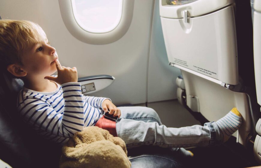 pensive-little-boy-sitting-on-an-airplane-2024-09-22-10-39-12-utc