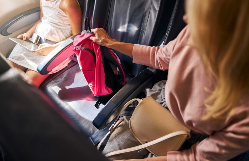 woman-is-picking-up-a-small-backpack-2025-03-06-16-02-41-utc