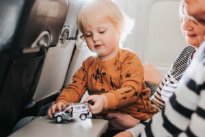 little-cute-boy-having-fun-sitting-on-a-plane_reduced