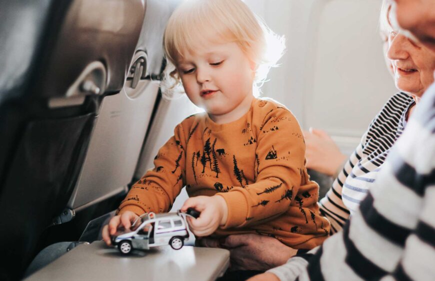 little-cute-boy-having-fun-sitting-on-a-plane_reduced