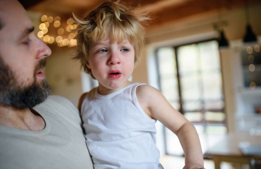 father-with-small-sick-unhappy-son-indoors-at-home-2024-10-18-20-56-57-utc