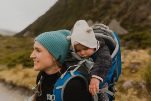 Hiker and baby exploring trail, Wanaka, Taranaki, New Zealand