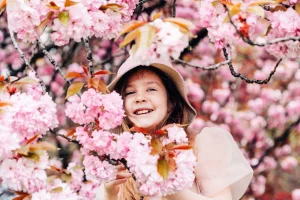 teenage-girl-in-pink-happily-smiles-among-the_japan_cherry-blossoms