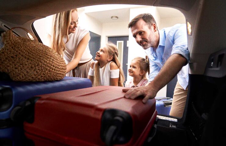 caucasian-family-of-four-packing-luggage-into-car-2024-11-29-11-55-27-utc