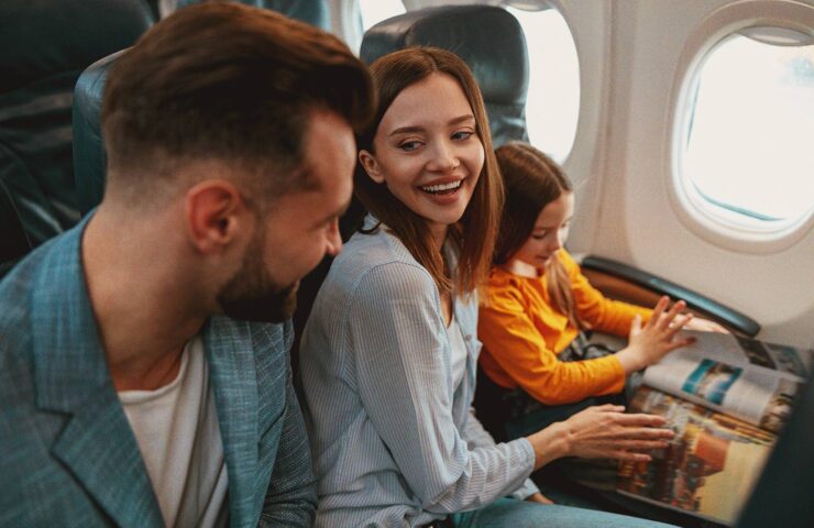 cheerful-parents-traveling-with-daughter-on-airpla-2025-03-26-12-15-04-utc