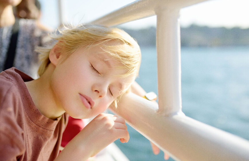cute-blonde-preteen-boy-is-traveling-by-boat-or-fe-2025-02-21-05-57-25-utc
