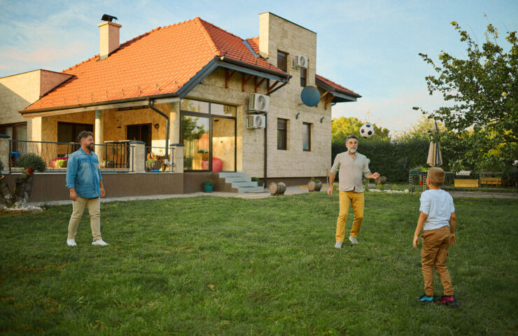 happy-family-playing-football-in-backyard-of-house-2025-03-30-22-17-12-utc