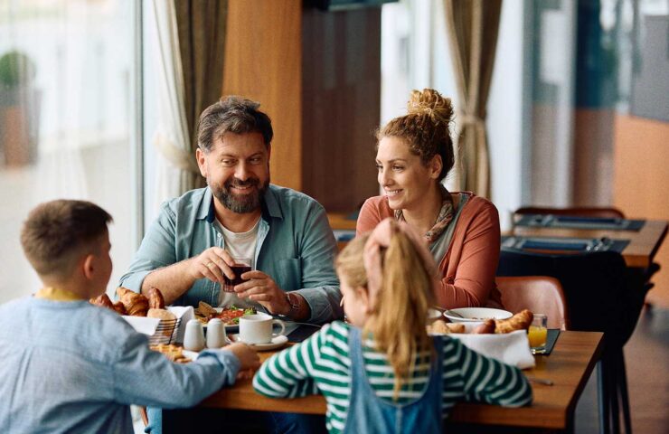 happy-family-talking-while-having-breakfast-in-a-r-2024-12-13-17-10-06-utc