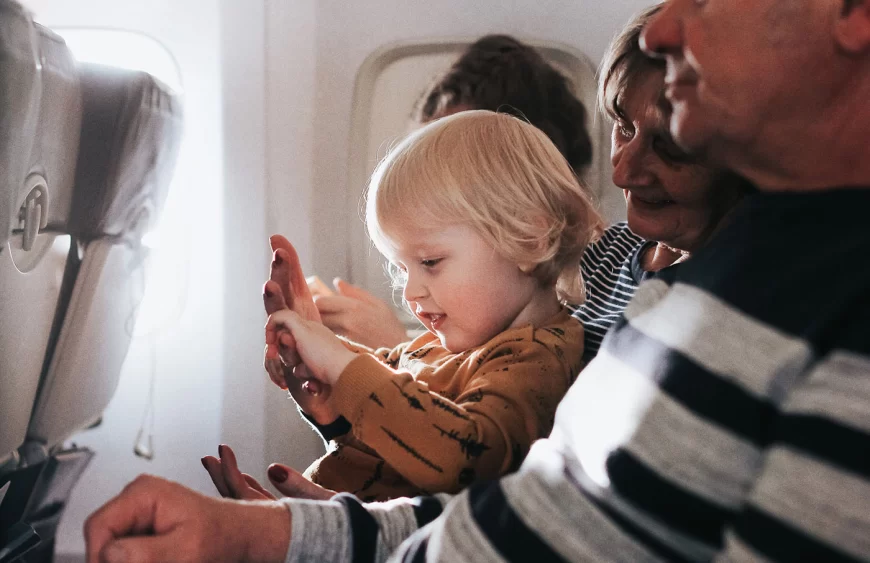 little-cute-boy-having-fun-sitting-on-a-plane-with-2024-12-02-21-25-07-utc.webp