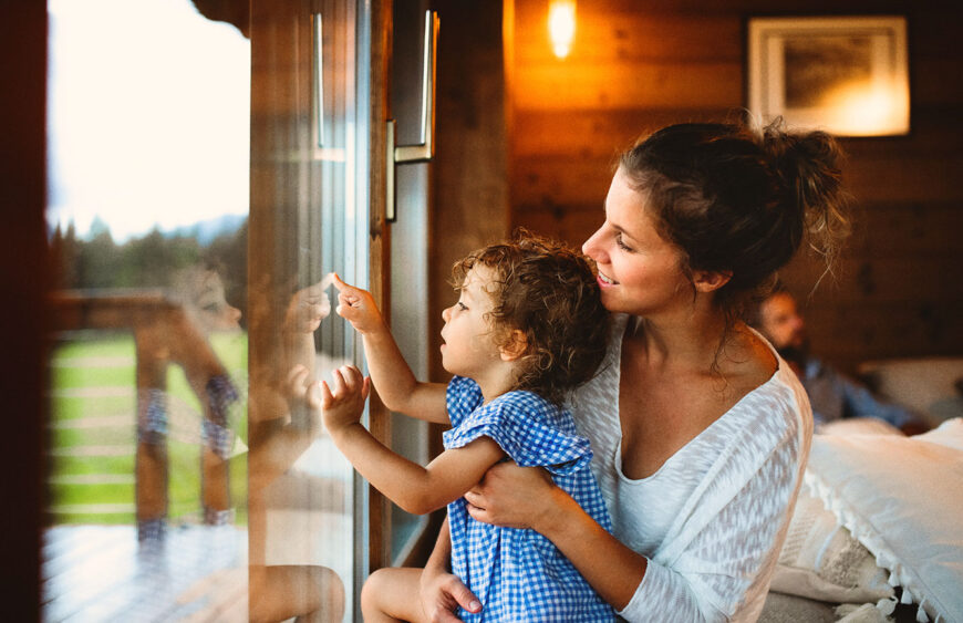 small-girl-with-parents-in-wooden-cabin-holiday-i-2024-10-18-14-42-29-utc