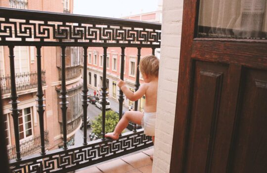 baby-toddler-on-seville-hotel-balcony-2024-11-02-01-12-04-utc