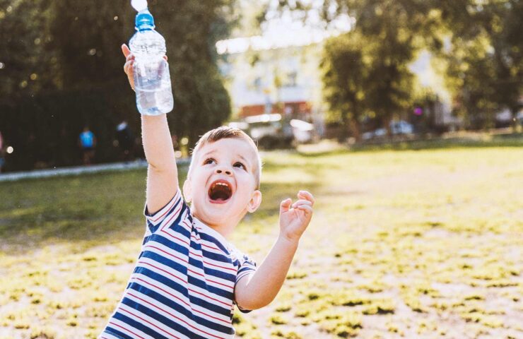 cool-baby-drinks-clean-water-from-a-bottle-on-a-su-2025-10-15-12-37-43-utc