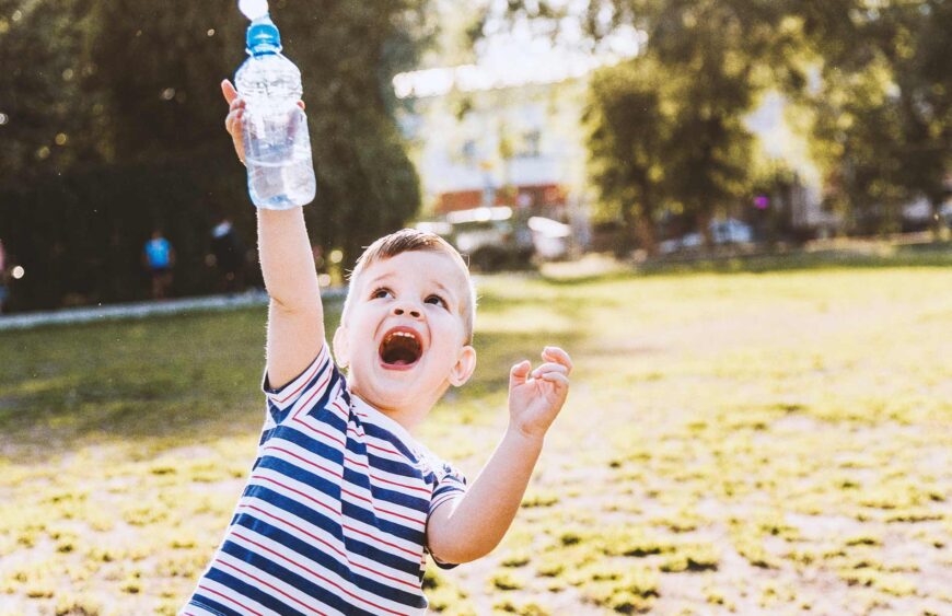 cool-baby-drinks-clean-water-from-a-bottle-on-a-su-2025-10-15-12-37-43-utc