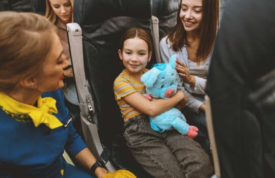 Little-girl-flight-attendant-and-mom-mother–on-plane