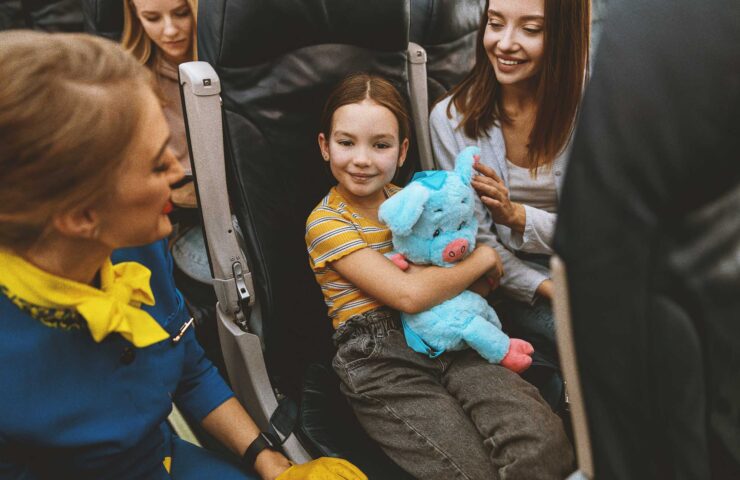 Little-girl-flight-attendant-and-mom-mother–on-plane