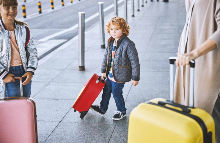 family-with-luggage-at-a-terminal
