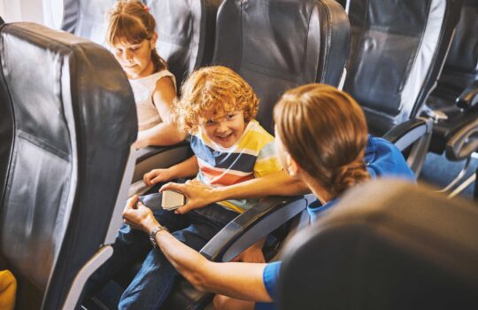 child-learning-about-airplane-safety-from-flight