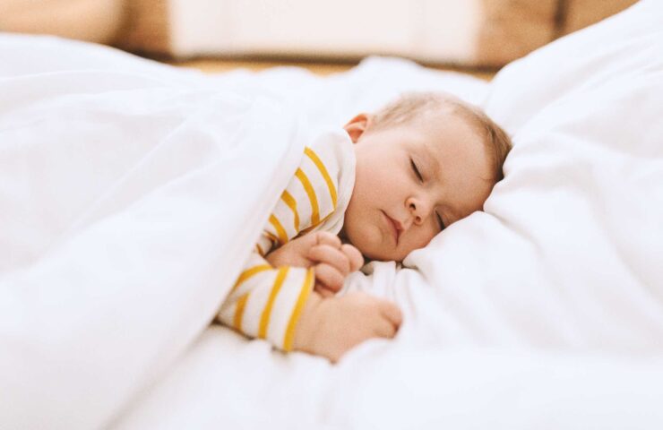 cute-infant-napping-peacefully-in-white-bed-2026-03-24-01-29-08-utc