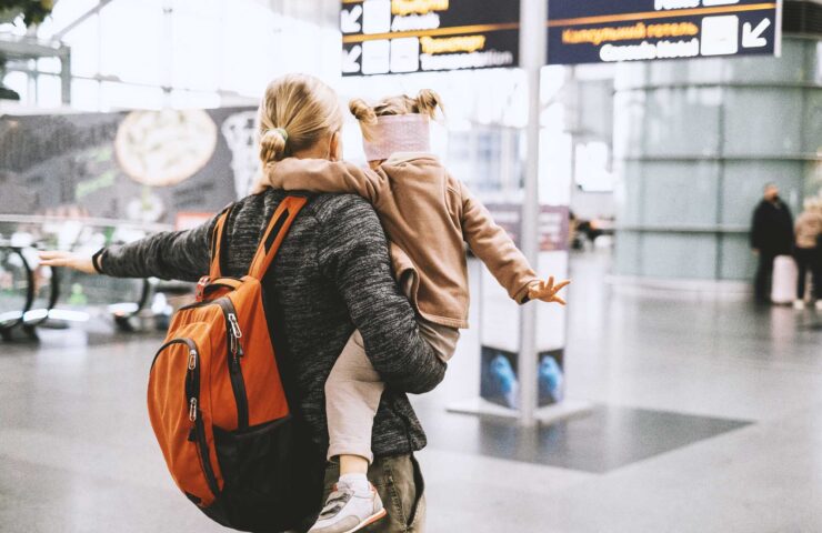 man-and-child-at-the-airport-with-backpack