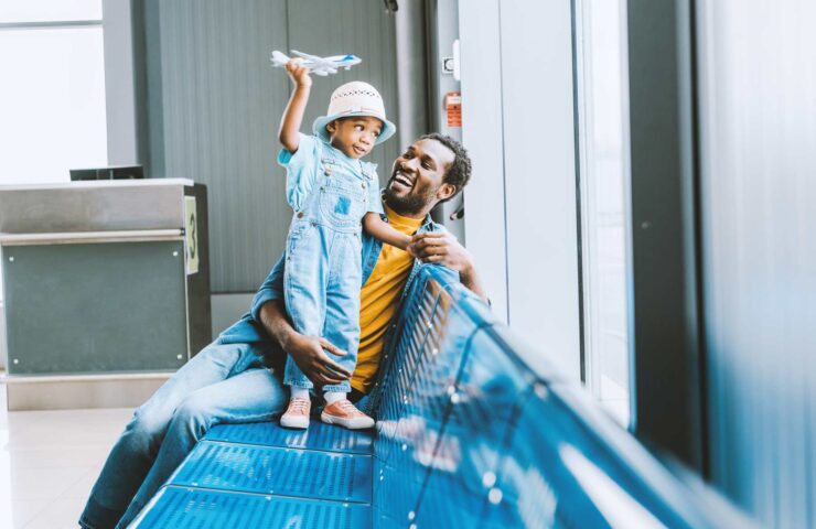 cheerful-toddler-with-toy-airplane-with-and-father